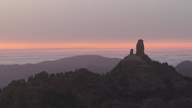 Stunning aerial view of the iconic Roque Nublo and Roque Rana in Gran Canaria, with a sea of clouds.