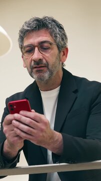 Video of smart businessman using smartphone in an elegant office