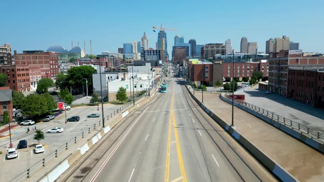 Aerial view of city skyline with streetcar passing underneath 