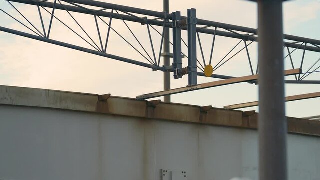 Close view of railway catenary gantry and steel infrastructure