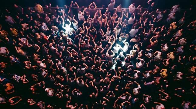 High angle view of a dancing crowd at a live music concert venue at night