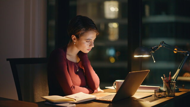 Tired business woman working laptop dark office night, closeup pensive face
