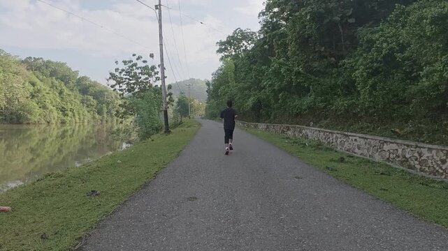Slow Motion of Man Running on a Rural Road