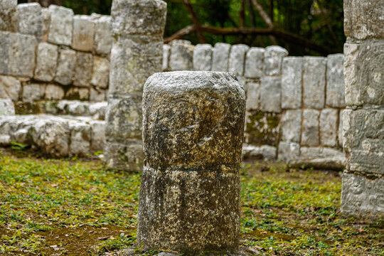 Close up of a small weathered stone column at the Xtoloc Temple ruins in Chichen Itza, Mexico