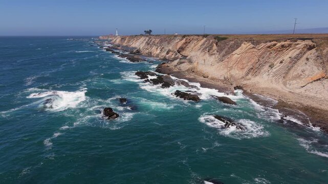 Enjoy aerial views of Point Arena Lighthouse overlooking the Pacific Ocean and coastline near Mendocino in northern California.