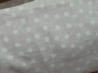 Grey fabric with light green mint polka dot pattern texture © PutPhoto