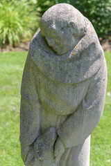 Obraz premium defocused view of St Francis and The Wolf by Thomas Bowie - sculpted 1956 from Indiana limestone, Guild Park and Gardens, Scarborough, Toronto