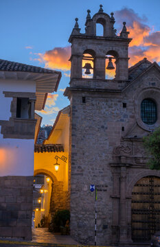 A narrow street and bell tower of the Chapel of San Antonio Abad at Plazoleta de las Nazarenas at early morning, Cusco, Peru.