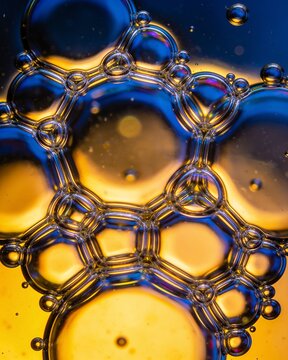 Abstract macro close up of soap bubbles creating a colorful geometric pattern of light