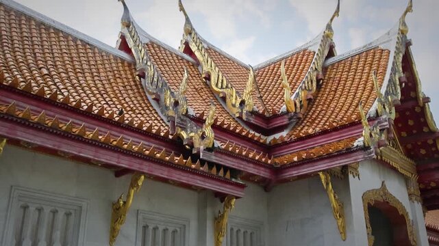 Detailed Gabled Roof Of Ornate Temple With Gold Trim And Decorative