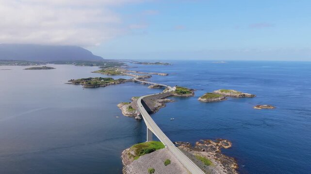 Aerial drone view of the Atlantic Ocean Road in Norway. Winding highway bridge connecting islands across rough ocean waves during a scenic coastal road trip.