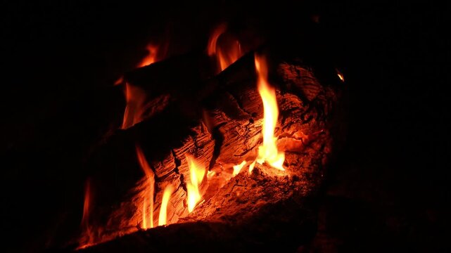 bright flame envelops cracked timber of night bonfire creating warm cozy glow
