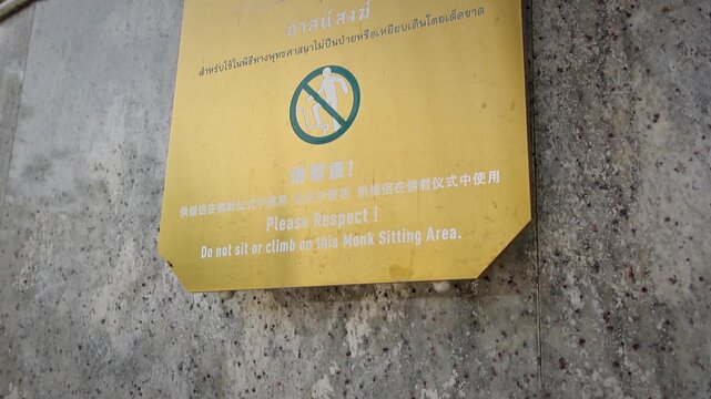 Warning Sign About Monk Sitting Area With English And Multilingual Text