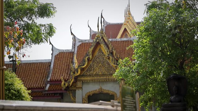 Ornate Temple Entrance With Decorative Gabled Roof And Carved Golden