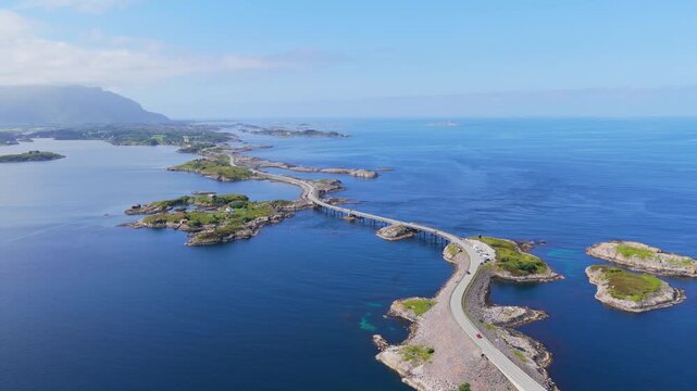 Aerial drone view of the Atlantic Ocean Road in Norway. Winding highway bridge connecting islands across rough ocean waves during a scenic coastal road trip.