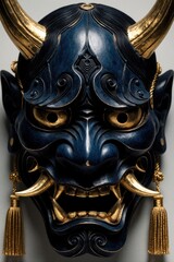 Fototapeta premium Japanese blue Oni mask with gold horns, teeth features intricate carvings. Dark demonic head sculpture displays fierce expression for traditional ritual dance. Asian cultural symbol represents myth