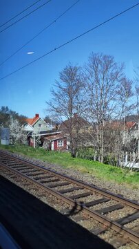 Huskvarna and lake V&auml;ttern in J&ouml;nk&ouml;ping Sweden city view from moving train vertical video