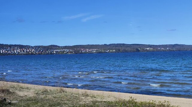 jonkoping lake vattern beach with clear blue sky view from train video