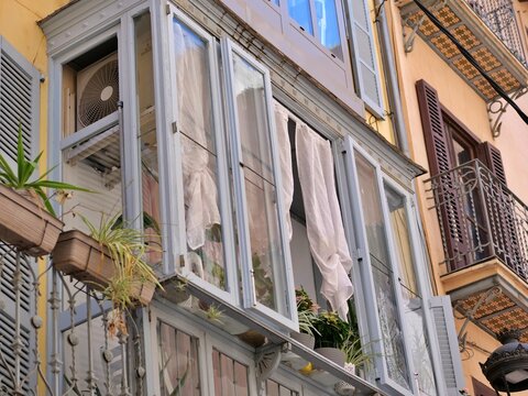 Traditional Enclosed Wooden Balcony with Potted Plants