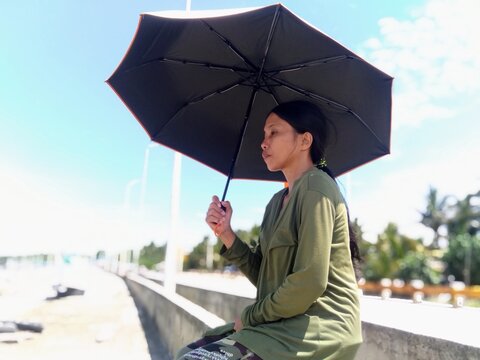 young woman with umbrella, embankment
