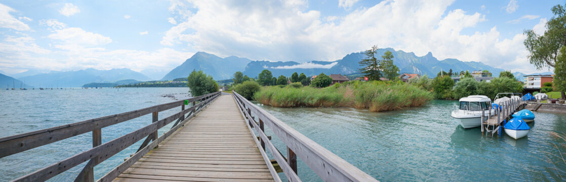 panorama landscape Gwatt, lake Thunersee. wooden bridge and Berner Alps view