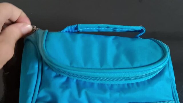 Blue backpack with zipper open for travel or school. Casual student or traveler accessory for daily use.