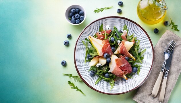 salad with pear arugula jamon blue cheese and blueberry delicious fresh salad appetizer on bright background