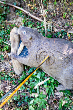 plastic animal hit by two arrows on an archery parcours in the nature.