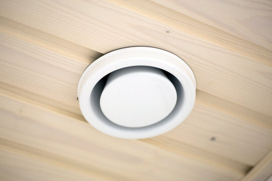 Round Ceiling Air Vent Installed in a Wooden Ceiling for Modern Home Ventilation.
