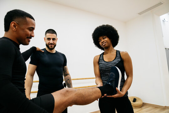 Friends helping each other during a workout session