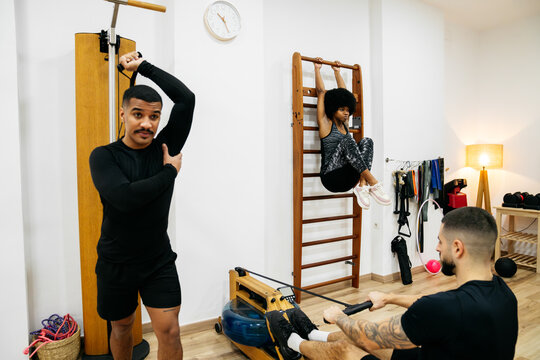 Friends working out together in a modern gym space