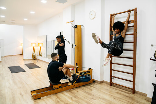 Friends exercising together in modern fitness studio