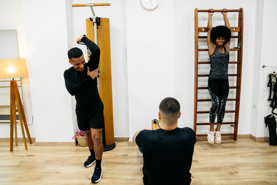 Friends exercising together in a modern gym setting