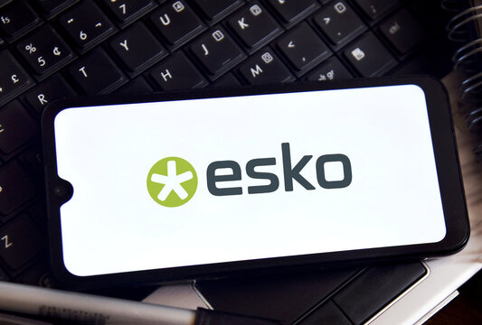Smartphone displaying Esko logo on a computer keyboard background