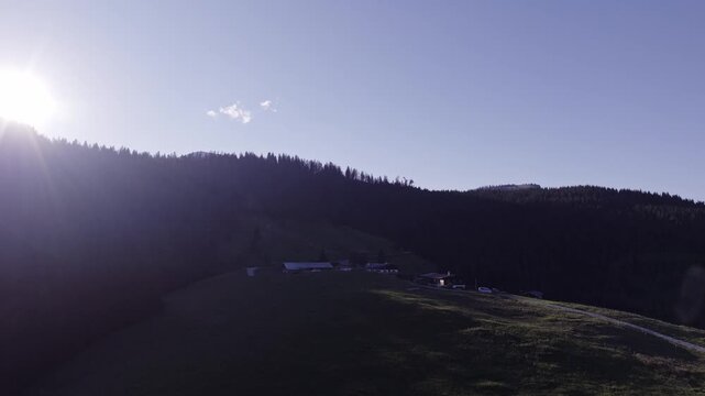 Aerial View of Alpine Farmhouses Framed by a Dramatic Mountain Range. Achenkirch, Austria