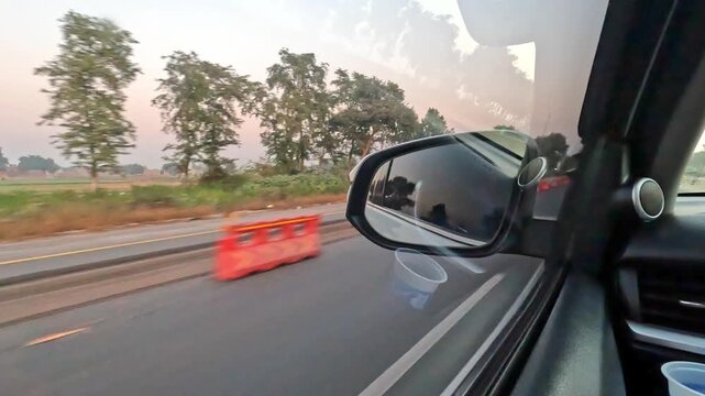 Red safety barriers along the slow lane on multiple lane highway or motorway for repairing and maintenance.