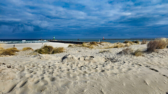 Wonderful views of the Baltic Sea town of Warnem&uuml;nde, featuring lighthouses, the beach, ships, and the water, all in beautiful weather 