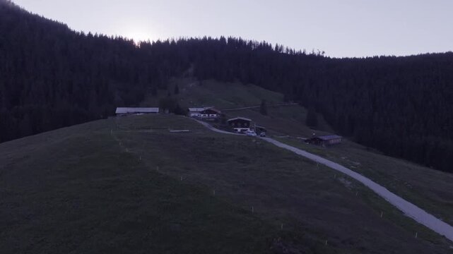 Aerial View of Alpine Farmhouses Framed by a Dramatic Mountain Range. Achenkirch, Austria