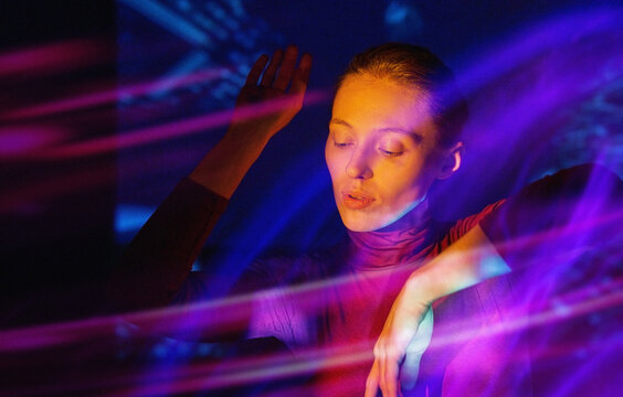 Woman immersed in virtual reality neon light experience