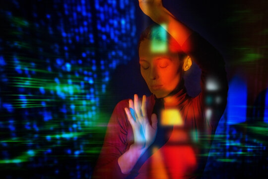 Woman interacting with virtual reality data light projection