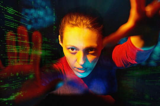 Woman reaching through digital interface in virtual reality