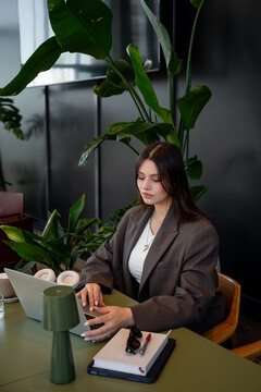 Businesswoman working in a modern cafe setting