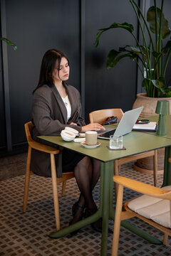 Businesswoman working in cafe for life balance