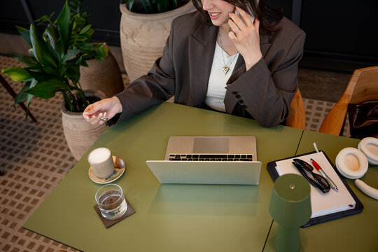 Businesswoman balancing work life in a cafe setting