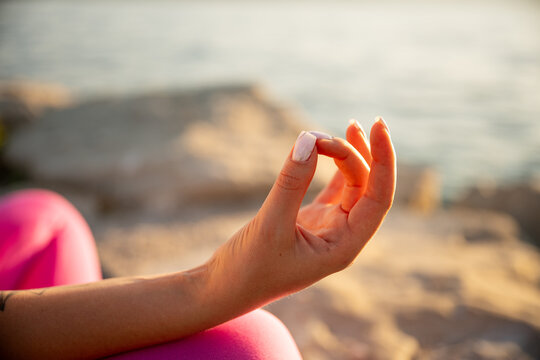 Woman meditating by the sea for calm life balance