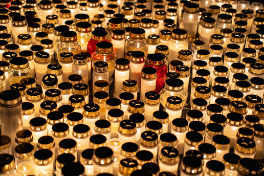 Candle lanterns glowing in cemetery for All Saints Day