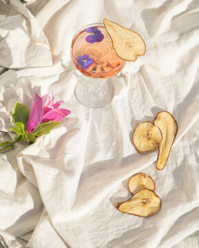 Two rose wine glasses on white fabric top view. Summer cocktails