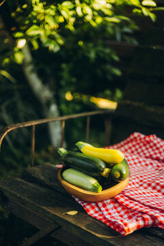 Freshly harvested zucchini in a wooden bowl