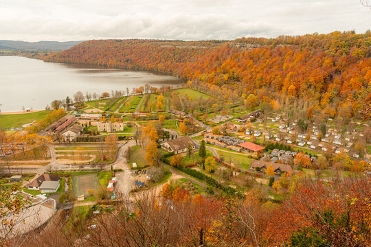 Colorful autumn landscape of lakeside village and hills