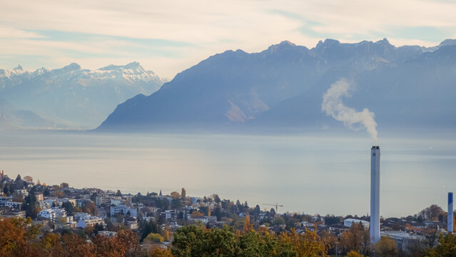 Colorful autumn lakeside town with mountain panorama